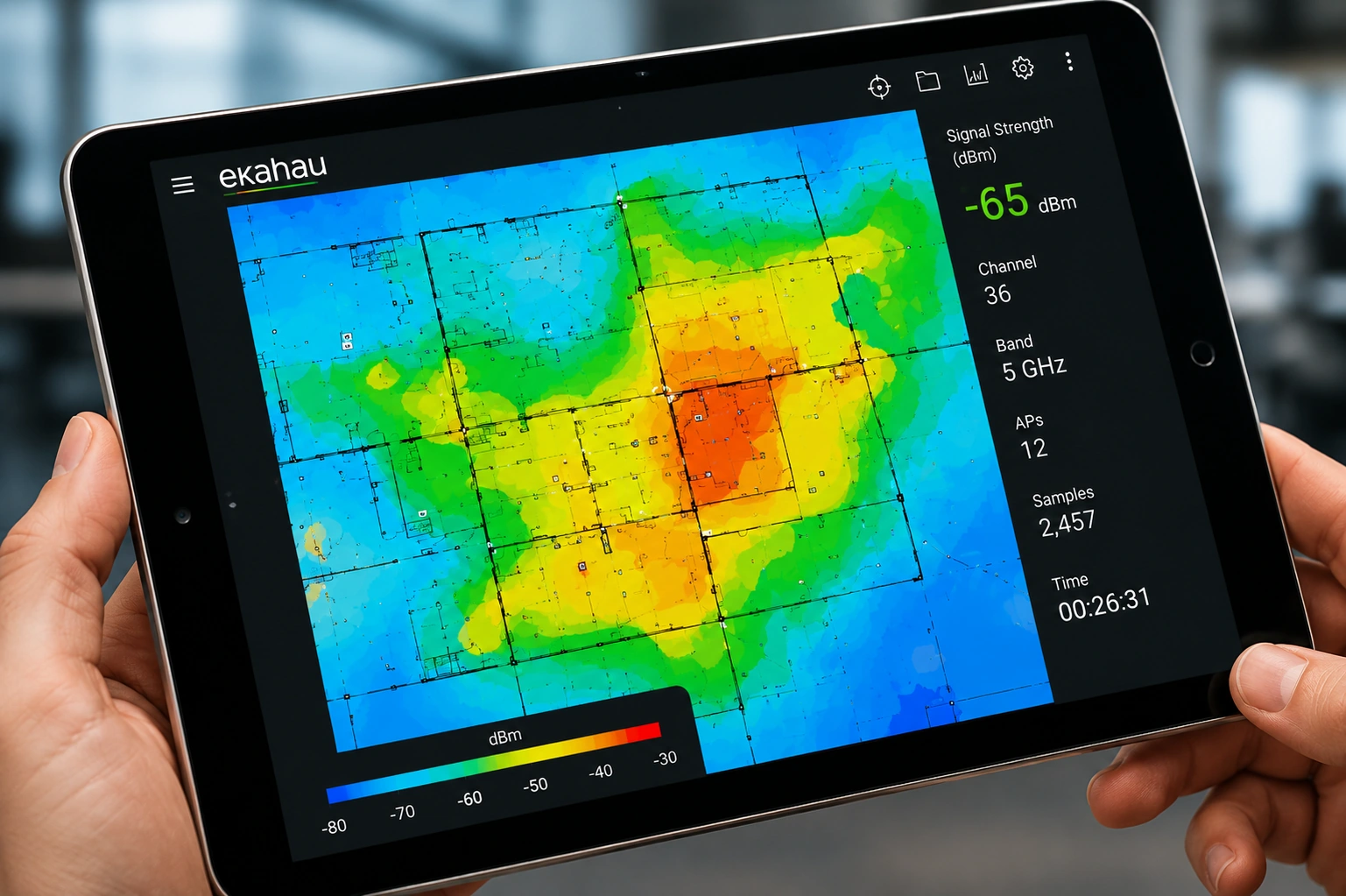 A tablet held in both hands showing a Wi-Fi survey heatmap with a signal strength readout in dBm alongside channel, band, access point count and sample count.